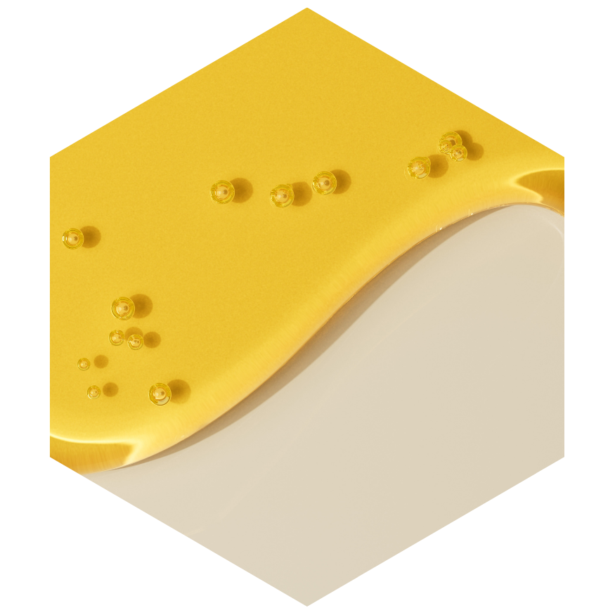 Hexagonal yellow soap bar with beige center on a white background
