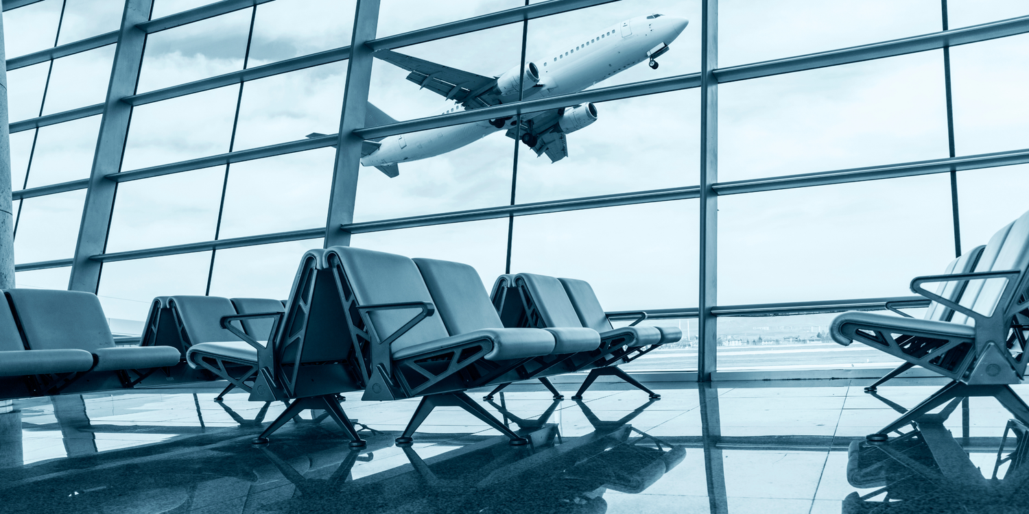 Airport terminal with seating area and airplane outside the window