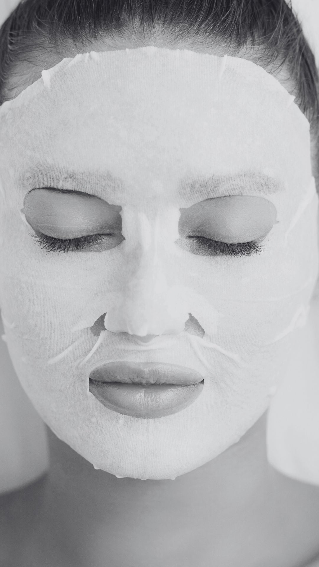 Person wearing a white face mask with a blurred background